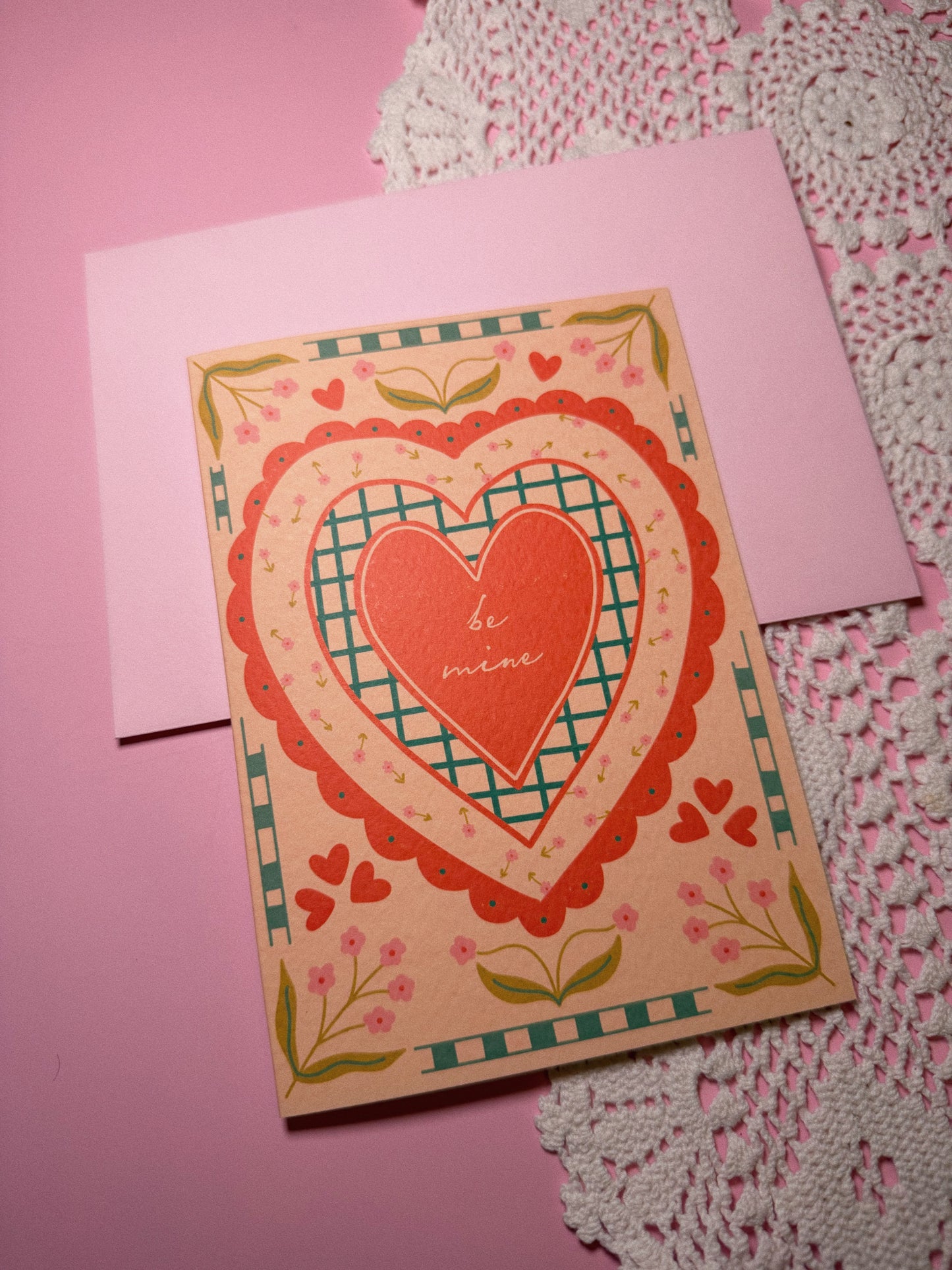Red Heart Card with Pink Envelope with the words Be Mine in the center set in a vintage style with pink floral details
